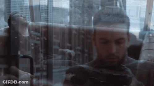 A Double Exposure Of A Man Taking A Picture With A Canon Camera GIF