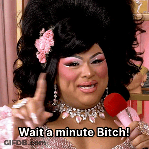 A Drag Queen Holding A Pink Microphone Says Wait A Minute Bitch GIF