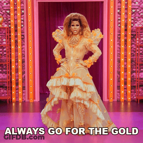 A Drag Queen In A Gold Dress With The Words Always Go For The Gold Underneath Her GIF