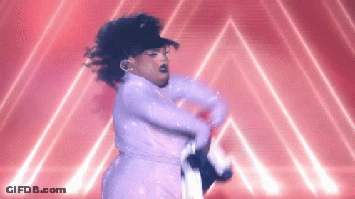 A Drag Queen In A White Dress Is Dancing On A Stage In Front Of A Red Background . GIF