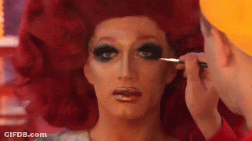 A Drag Queen Is Getting Her Makeup Done By A Man With A Brush . GIF