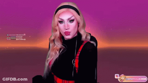 A Drag Queen Is Giving A Kiss In Front Of A Screen That Says ' Neueslacok ' On It GIF