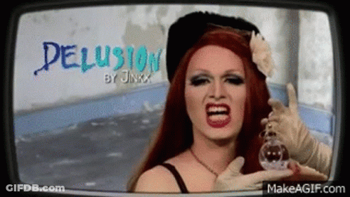 A Drag Queen Is Holding A Bottle Of Perfume In Front Of Her Face And Screaming . GIF