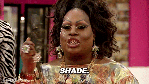 A Drag Queen Is Holding A Mirror And Says Shade GIF