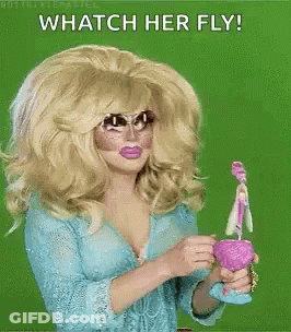 A Drag Queen Is Holding A Toy And Says Whatch Her Fly ! GIF