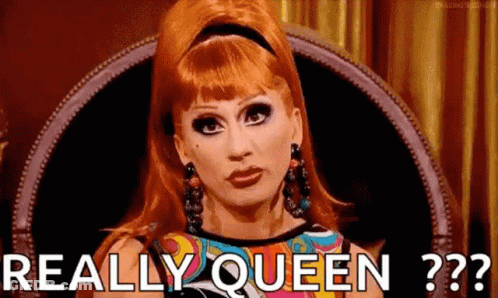 A Drag Queen Is Sitting In A Chair With The Words `` Really Queen '' Written On Her Face . GIF