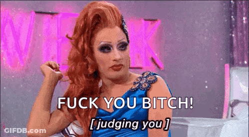 A Drag Queen Is Sitting On A Couch And Saying `` Fuck You Bitch ! Judging You '' . GIF