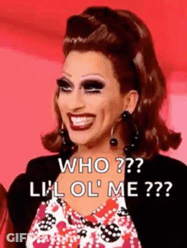 A Drag Queen Is Smiling And Asking Who ? Lil Ol ' Me ? . GIF