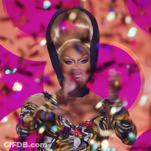 Drag Queen In Front Of Pink Background With Confetti GIF