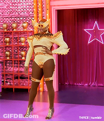 Drag Queen Standing On Stage In Front Of Star GIF