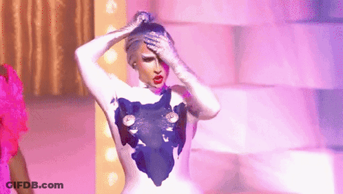 A Drag Queen Is Standing On A Stage With Her Hands On Her Head And A Purple Background . GIF