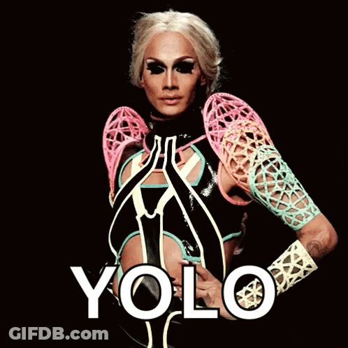 A Drag Queen Is Wearing A Colorful Outfit And The Word Yolo Is On The Bottom Right GIF