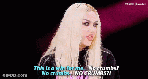 A Drag Queen Is Wearing A Yellow Feathered Headpiece And Earrings And Says This Is A Win For Me . GIF
