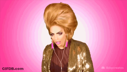 A Drag Queen Is Wearing Headphones And A Sequined Jacket With Libbycreates Written On The Bottom GIF