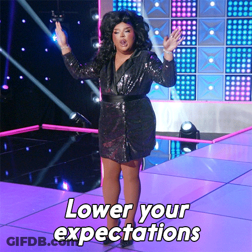 Drag Queen On Stage With Lower Your Expectations GIF