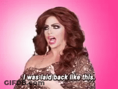 A Drag Queen Says I Was Laid Back Like This On A Pink Background GIF