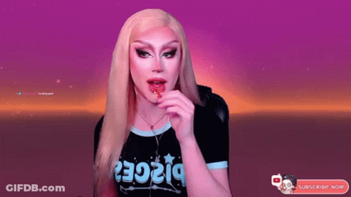 A Drag Queen Wearing A Black Shirt That Says ' Piece ' On It GIF