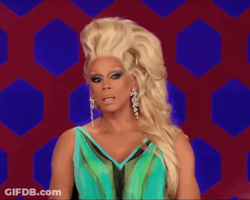 A Drag Queen Wearing A Blue And Green Dress GIF