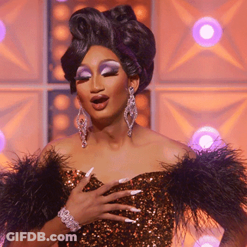 Drag Queen In Feathered Dress And Earrings GIF
