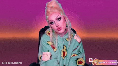 A Drag Queen Wearing A Green Hoodie With Avocados On It GIF