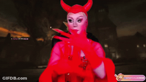 A Drag Queen Wearing A Red Devil Costume With Horns GIF
