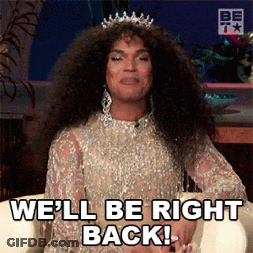 A Drag Queen Wearing A Tiara Is Sitting In A Chair And Saying We 'Ll Be Right Back . GIF