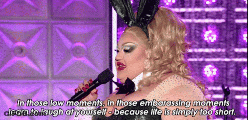 A Drag Queen Wearing Bunny Ears Is Singing Into A Microphone While Wearing A Bunny Costume . GIF