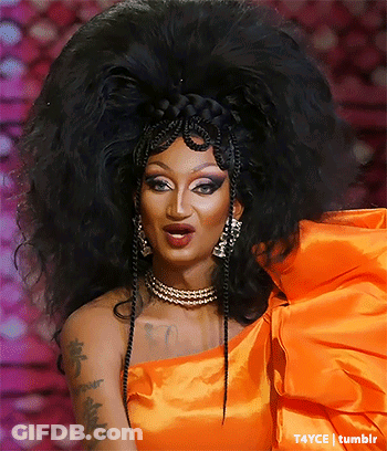Drag Queen With Large Wig In Bright Orange Dress GIF
