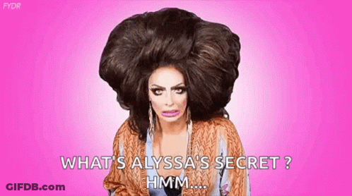 A Drag Queen With A Very Large Wig On Her Head Is Asking What 'S Alyssa 'S Secret . GIF