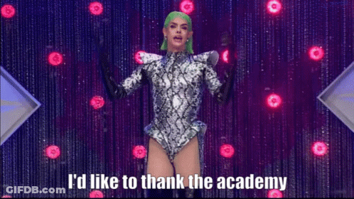 A Drag Queen With Green Hair Says I 'D Like To Thank The Academy On Stage GIF