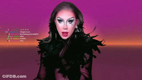 A Drag Queen With Her Tongue Hanging Out Is On A Purple Screen GIF