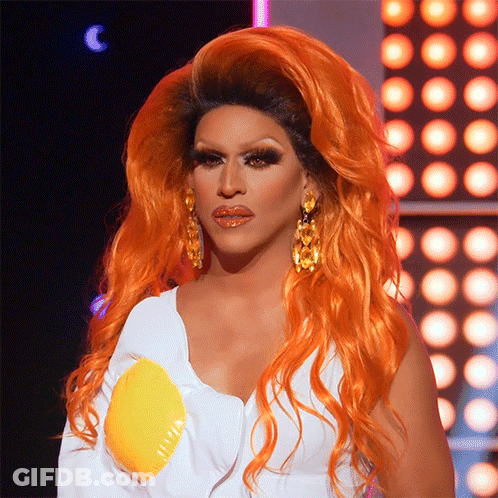 Drag Queen With Orange Hair And Earrings GIF