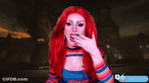 A Drag Queen With Red Hair And Freckles Is Pointing At Something GIF