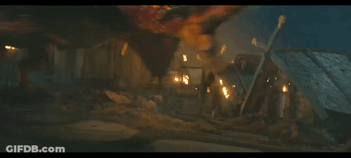A Dragon Is Flying In The Dark With Flames Behind It GIF