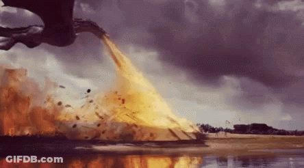 A Dragon Is Flying Over A Body Of Water And Throwing Fire Into The Air . GIF