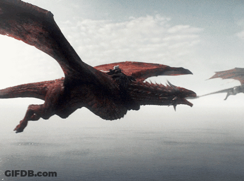 A Dragon Is Flying Over A Body Of Water With Its Wings Outstretched GIF