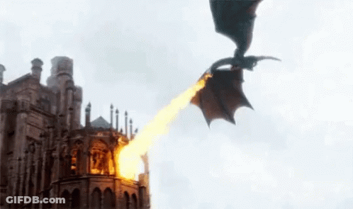 A Dragon Is Flying Over A Building With Fire Coming Out Of It 'S Mouth . GIF