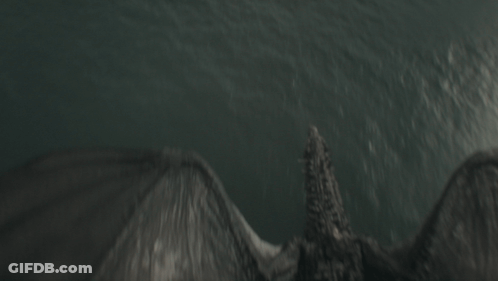 A Dragon Is Flying Over The Ocean With Its Wings Spread GIF