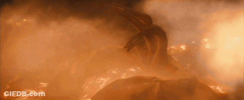 A Dragon Is Flying Through A Cloud Of Flames In The Sky . GIF