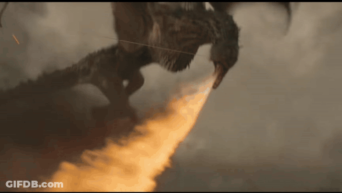 A Dragon Is Flying Through The Air With A Flame Coming Out Of Its Mouth . GIF