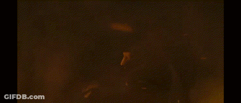 A Dragon Is Flying Through The Air With Flames Coming Out Of It 'S Mouth GIF