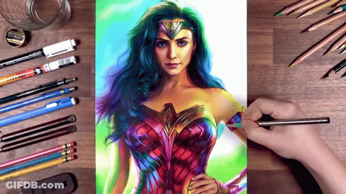 A Drawing Of Wonder Woman Is On A Table With Pencils And Pens GIF