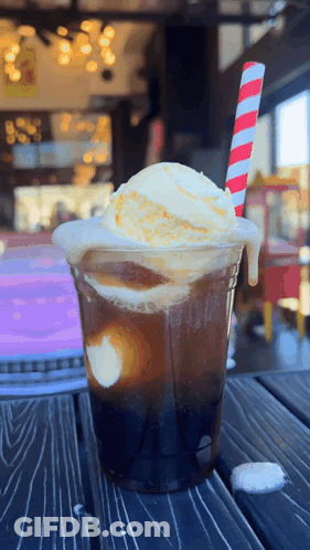 A Drink With Ice Cream And A Striped Straw GIF