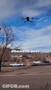A Drone Is Flying Over A Parking Lot With The Words @Bumsnddrones Written On The Bottom GIF