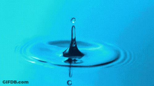A Drop Of Water Falls Into A Blue Liquid GIF