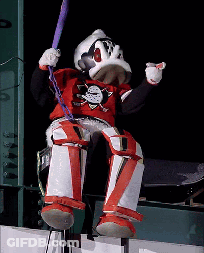 A Duck Mascot Is Holding A Bat And Wearing A Shirt That Says Ducks On It GIF
