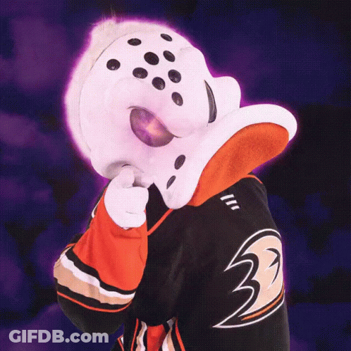 A Duck Mascot Is Pointing At Something With His Tongue Out GIF