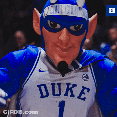 A Duke Basketball Mascot Wearing A Devil Costume And A Sign That Says " I Can 'T Touch This " GIF