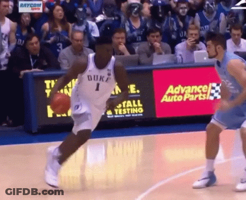 A Duke Basketball Player Dribbles The Ball In Front Of An Advance Auto Parts Ad GIF