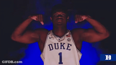 A Duke Basketball Player Flexes His Muscles In The Dark GIF